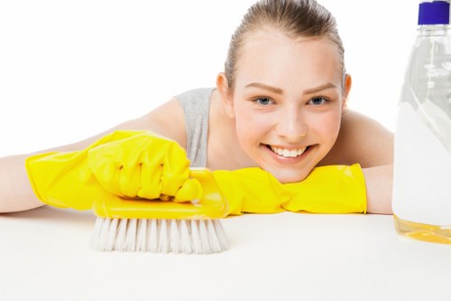 Local oven cleaner working in a compact Finsbury Park flat kitchen